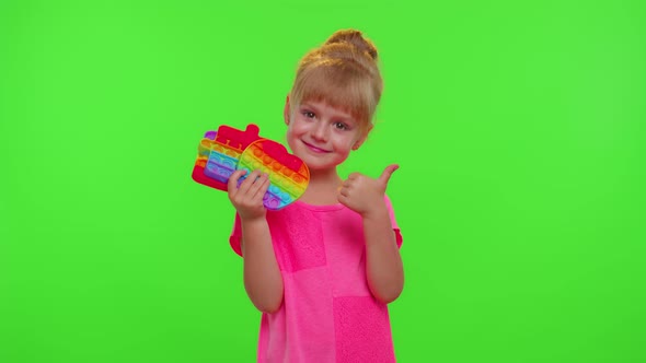 Child Girl Holding Many Colorful Squishy Silicone Bubbles Pop It Popular Sensory Toys Thumb Up alt