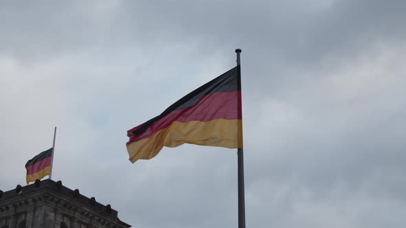 Low Angle View of Two German National Flags Waving in Wind alt