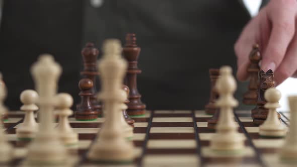 The Chess Player Makes The Bishop Move With The Queen. An Officer Performing A Chess Move alt