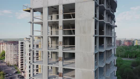 Aerial view of high residential apartment building under construction. Real estate development. alt