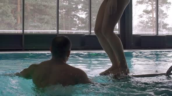 Woman Jumping into Pool alt