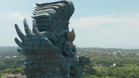 Side Dolly Aerial View of Giant Garuda Wisnu Kencana Statue in Bali Indonesia alt