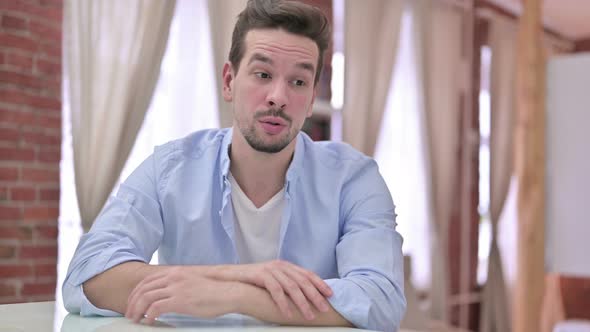 Ambitious Young Man Doing Video Chat at Home  alt