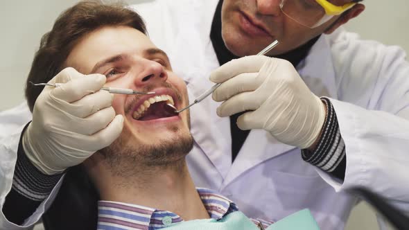 Handsome Young Man Smiling During Dental Examination alt
