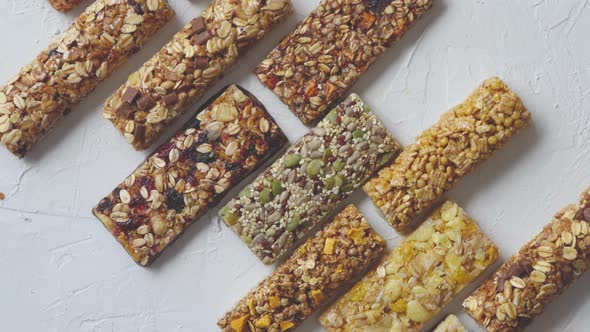 Row of Mixed Gluten Free Granola Cereal Energy Bars. With Dried Fruits and Nuts. alt