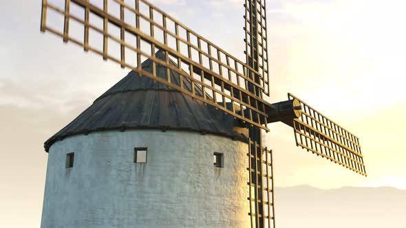 Closeup shot of a vintage Spanish windmill's wings rotating slowly at sunset. 4K