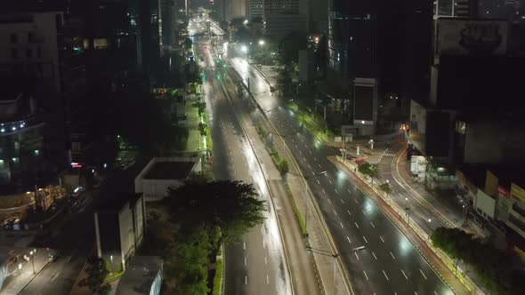 Low Flying Aerial Dolly Shot Flying Above Empty Multi Lane Highway Through Urban City Center with alt