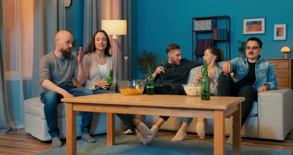 Two Couples in Love and One Single Sitting on Couch in Evening Spending Time Together alt