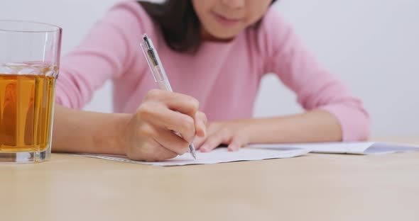 Woman doing revision on her note, study for exam alt
