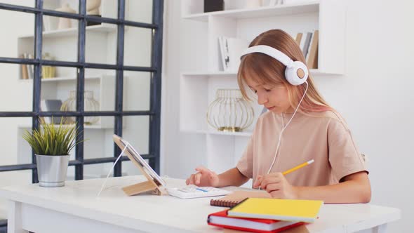 Teenage Girl Studying Online From Home with Distance Teacher