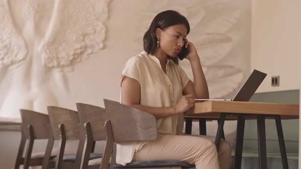 Woman Working in Cafe Alone alt