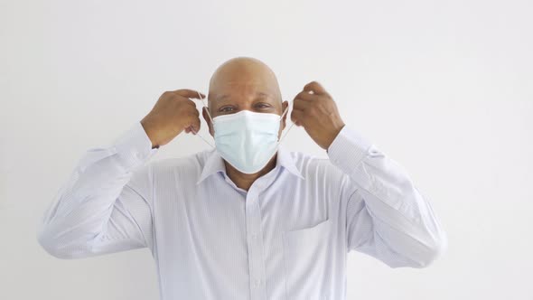 Old elderly black business man. Sick African American person wearing a face mask