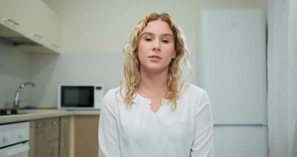 Student with Fair Hair Presents Answer Sitting at Laptop alt