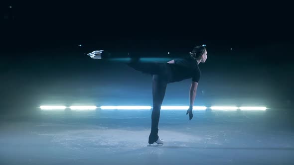 Young Girl is Doing a Camel Spin While Skating alt