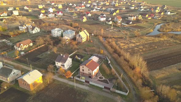 Aerial Landscape of Small Town or Village with Rows of Residential Homes and Green Trees alt