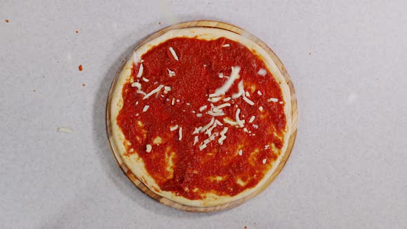 Cheese Falls on the Pizza. Cheese and Pizza. Pizza Production. Cheese Tinder on Dough. alt