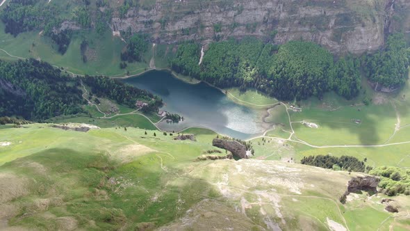 Flying over Seealpsee lake in the Alpstein range, Appenzell Alps, Switzerland alt