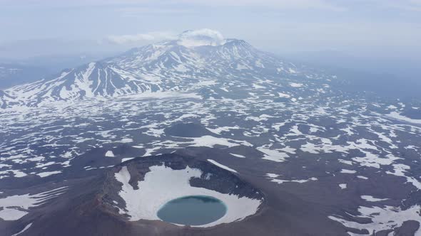 Gorely Volcano Crater Lake with Mutnovsky Volcano on the Background