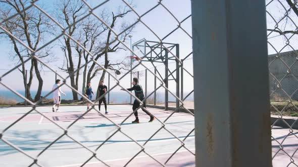 Group of People Playing Basketball Outdoors Slow Motion alt