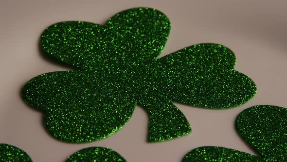 Rotating stock footage shot of St Patty's Day clovers on a white surface - ST PATTYS 009 alt