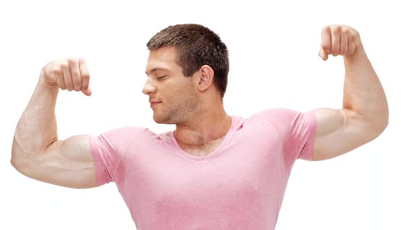 Young Sportive Man Showing Muscles Smiling Over White Background Slow Motion