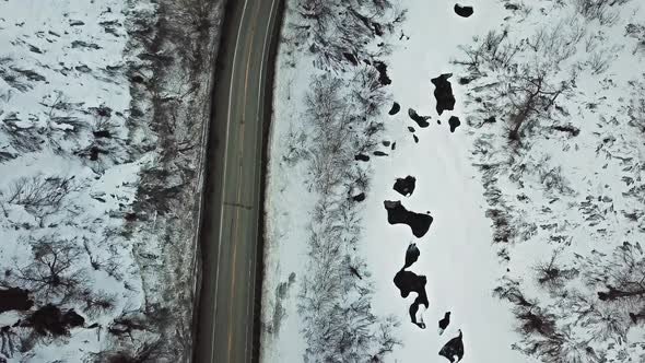 Flying over country road with snow to the sides. alt