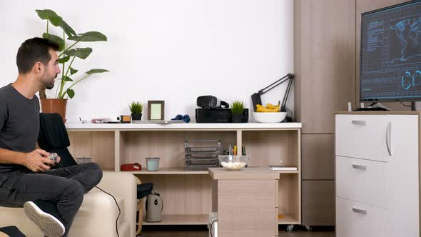 Man in the Living Room Playing a Video Game on Console alt