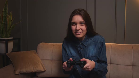 Woman Playing a Video Game at Home alt