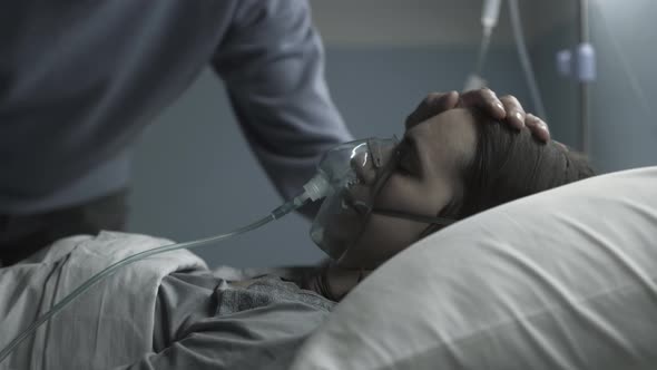 Loving father assisting her sick daughter at the hospital