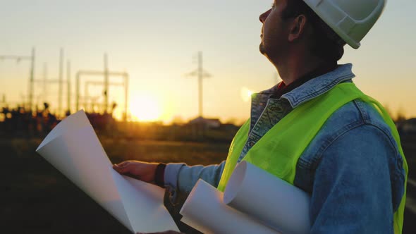 Architect Worker Checking Construction Project On Electric Tower alt