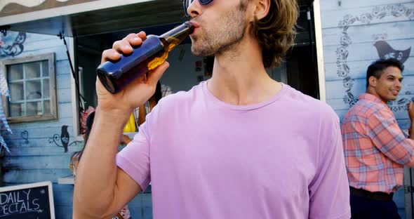 Handsome man drinking beer alt