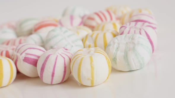 Slow pan on traditional sugar candies in various colors close-up 4K video alt