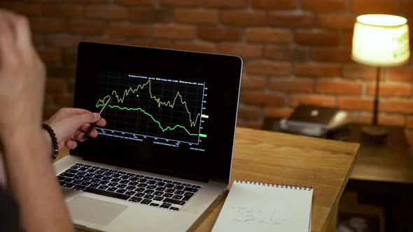 Young Successful Businessman Speaking on Phone Working in Office at Night alt