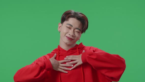 The Smiling Asian Transgender Male Dancing While Standing On Green Screen In A Green Screen Studio alt