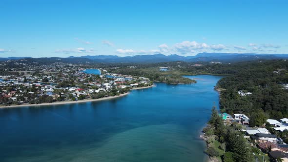 High drone view of Tallebudgera Creek and estuary with a mountain backdrop Gold Coast Australia alt