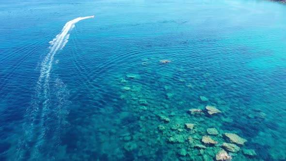 Aerial View of a Motor Boat Towing a Tube. Zakynthos, Greece