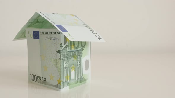 Hundred euro banknotes arranged like house on  white 4K 2160p 30fps UltraHD  tilting   footage - Con alt