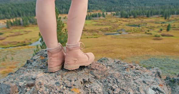 Close Up Woman Legs in Pink Hiking Boots on the Rock with Green Forest View alt