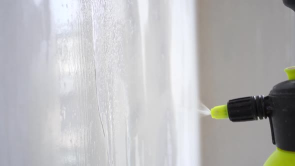 Priming the Wall Surface with an Atomizer Close-up in Slow Motion
