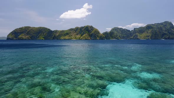 Aerial Low Altitude Fly Over Open Ocean Towards Tropical Islands alt