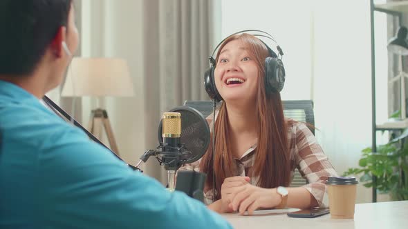 Asian Man Host Record Podcast Interview Happy Female Guest Conversation In His Home Studio alt