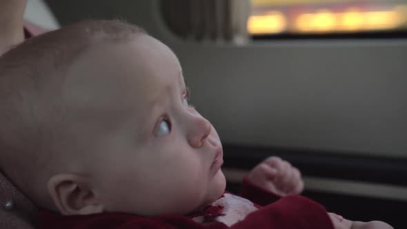 Cute Baby Girl of Six Months Traveling with Mum By Car alt