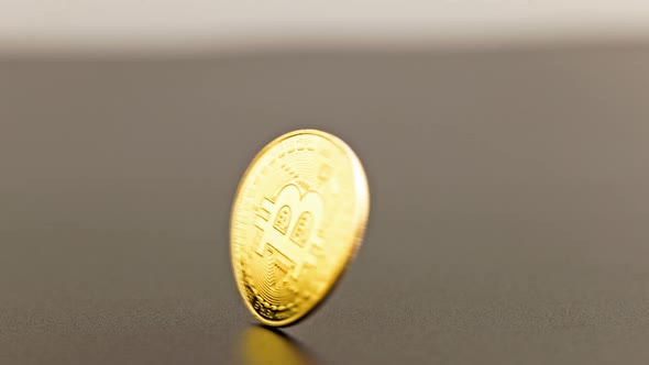 Bitcoin Coin Spinning on Gray Background  Closeup with Slowmo