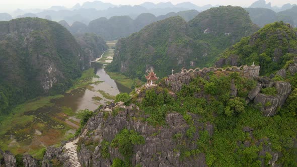 Aerial Shot of the Small Temple and a Dragon on the Top of Marble Mountain Mua Cave Mountain in Ninh alt
