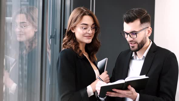 Close Up Business Partners Discussing Something at Window alt