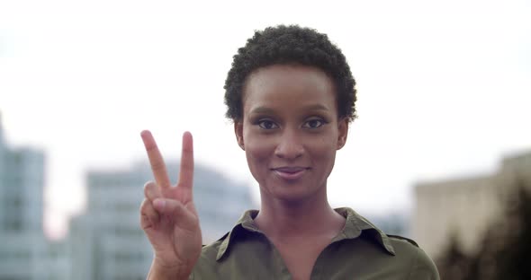 Portrait Attractive African Woman with Short Hair Standing Posing in Front of Camera, Counting Three alt
