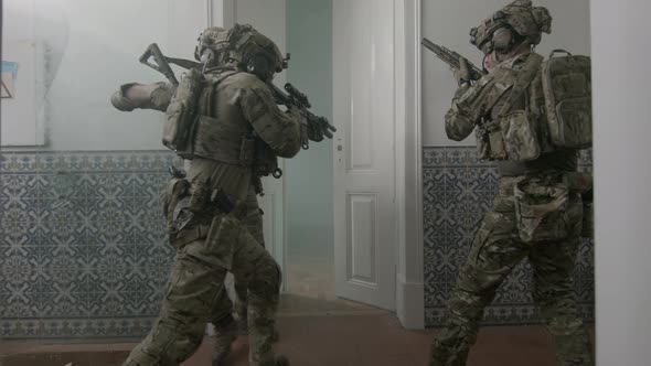 Armed Men Opening Door of Ruined Building with Foot alt