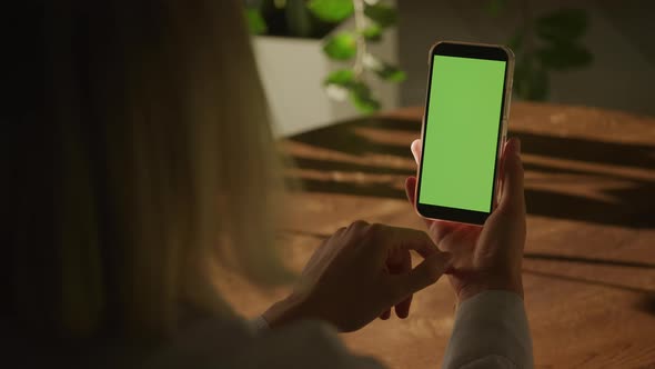 Handheld Close Up of a Woman Holding Smart Phone with Green Screen Chroma Key and Single Swipe alt