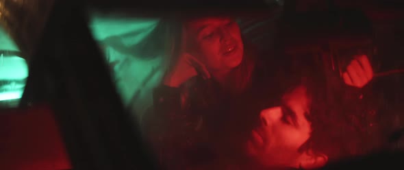 Woman plays with Mans hair in car alt