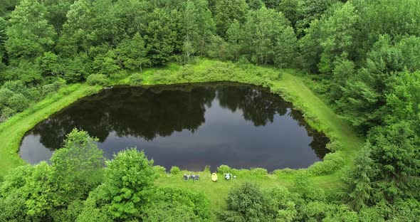 A drone peeps over the top of the trees to see a private fishing pond in the Catskill mountains of N alt